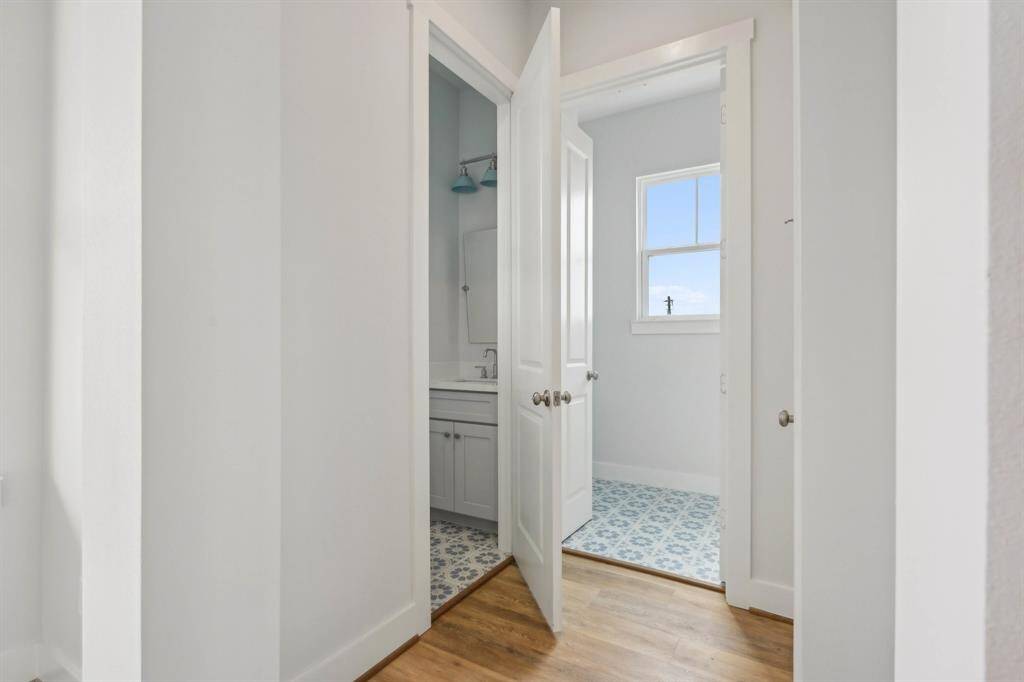 Looking towards the half bath, and laundry. The fun tile adds a pop of color!