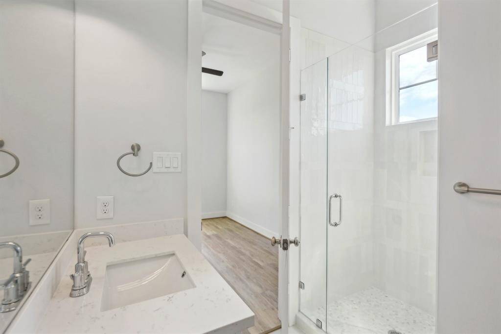The walk-in shower with neutral tile.