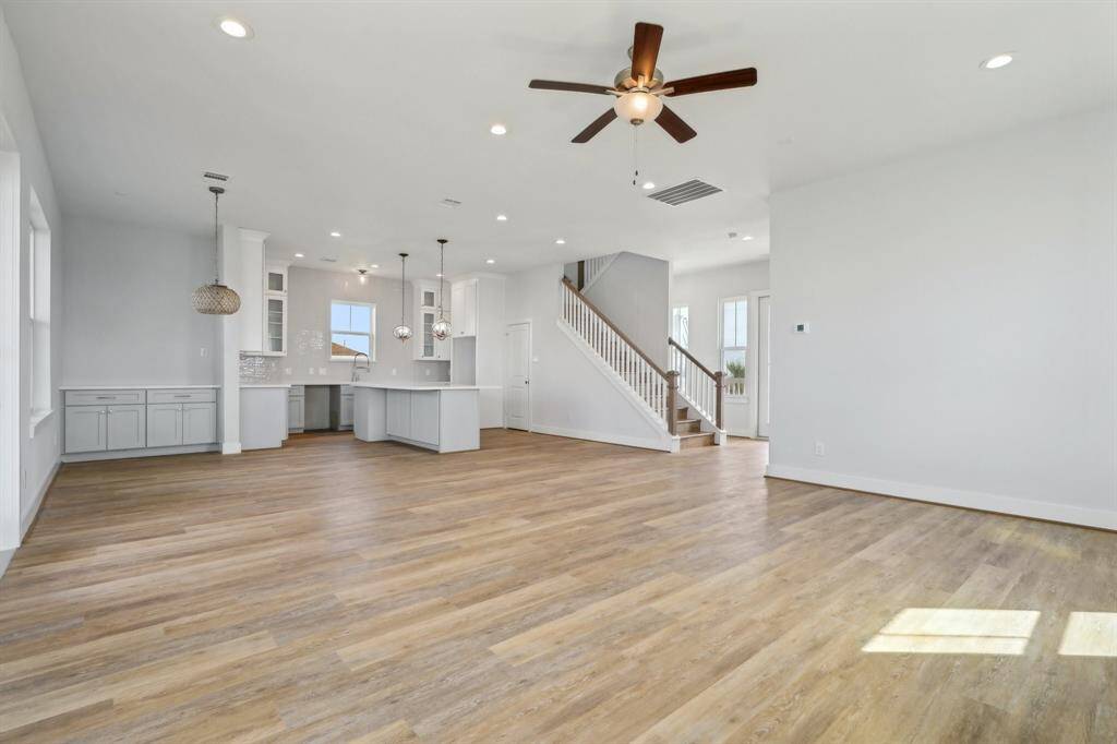The living area flows seamlessly into the kitchen and dining space, highlighted by continuous LVP flooring throughout.