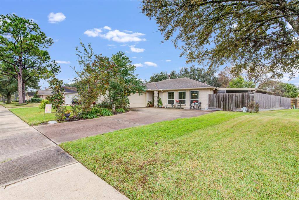 Charming single-story home with a spacious front yard and driveway. Features mature trees and a privacy fence on the side. Located in a quiet 55+ neighborhood with sidewalk access.