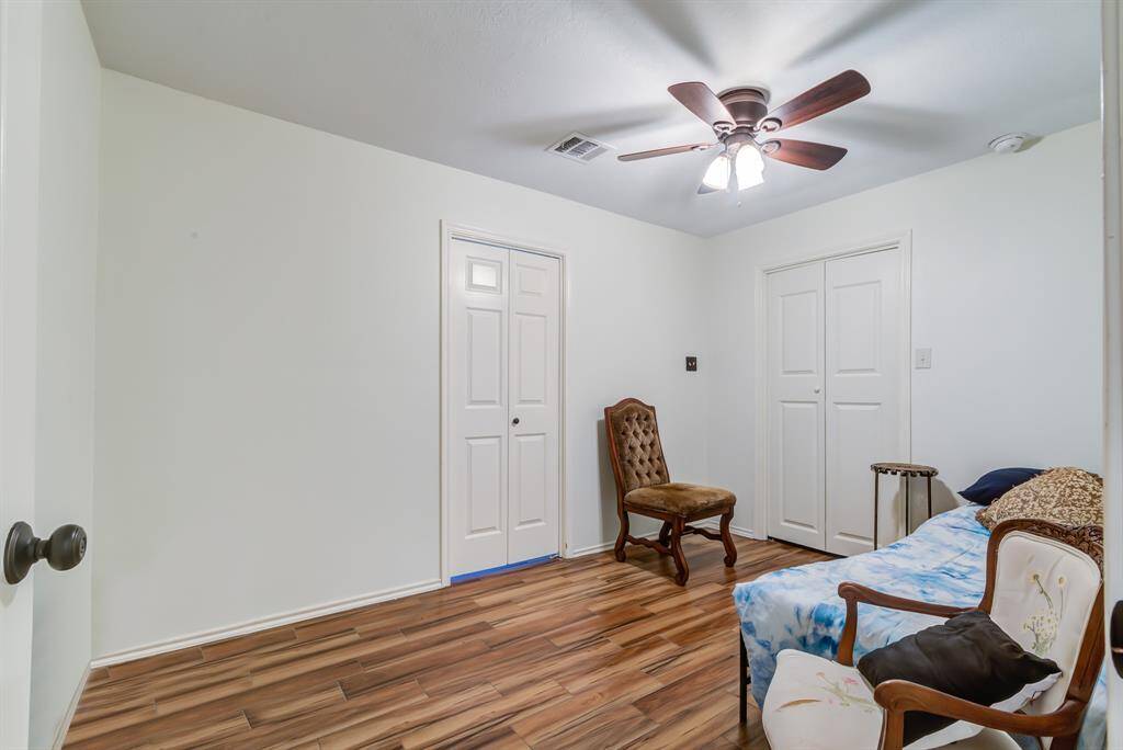 Second bedroom featuring neutral-colored walls, making it versatile for any decor style.
