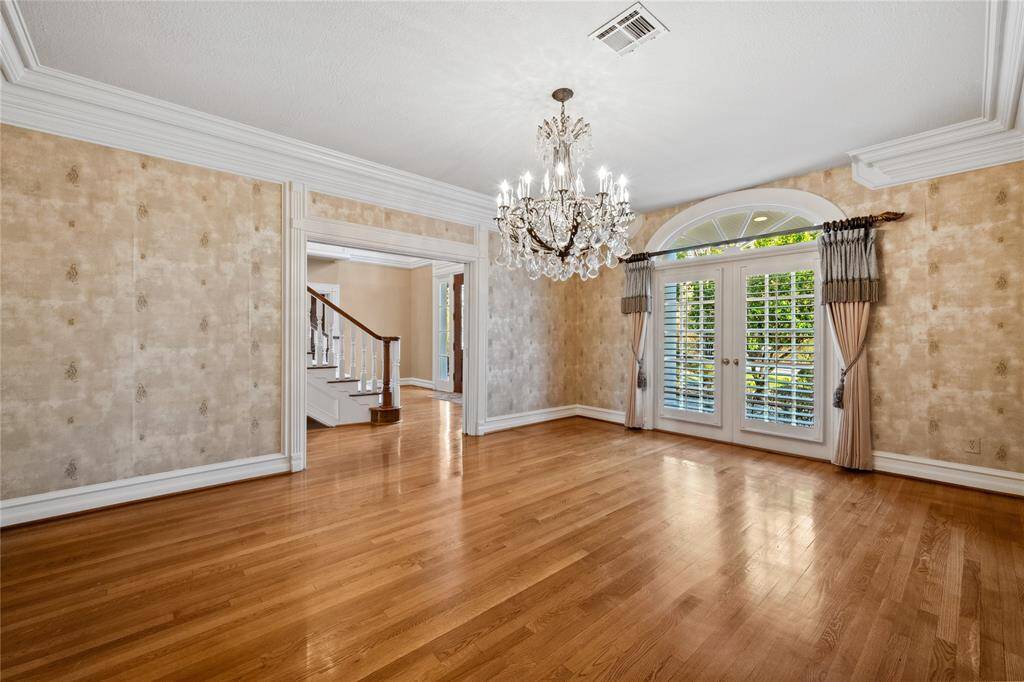 Gorgeous Formal Dining... impressive chandelier... Plantation shutters, of course!