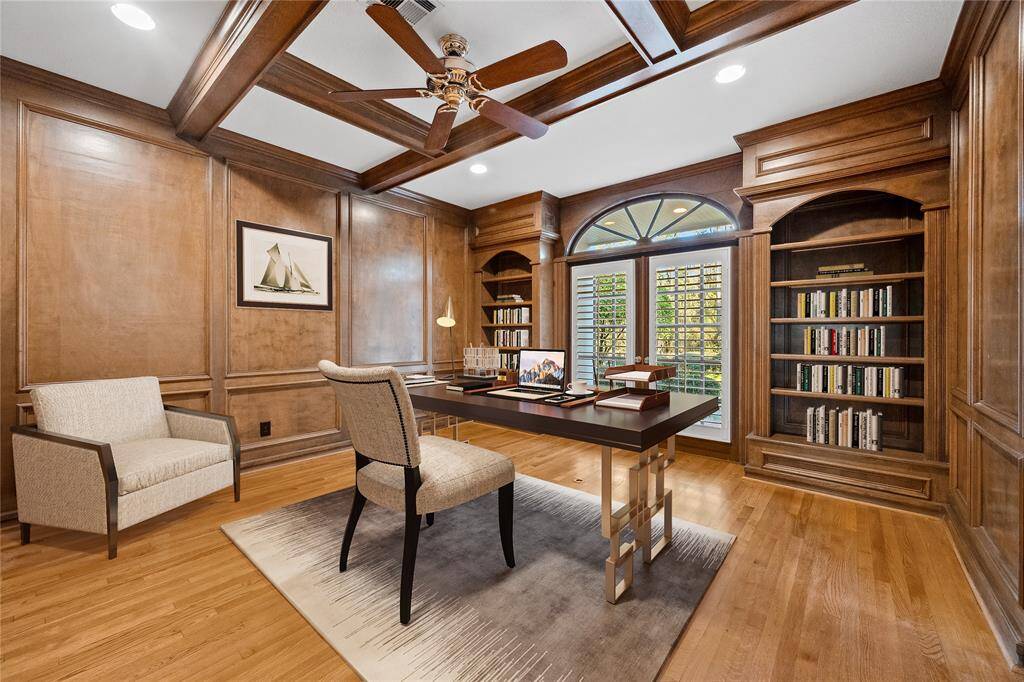 Study... off the entry foyer... Wood floors, Beamed ceiling... impressive built-in shelving... Plantation shutters...