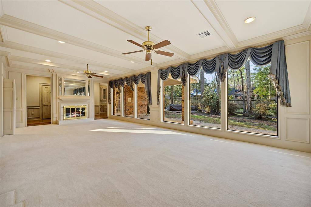Large living area has gas log fireplace, marble ... beautiful wood and mirrors... lots of windows...