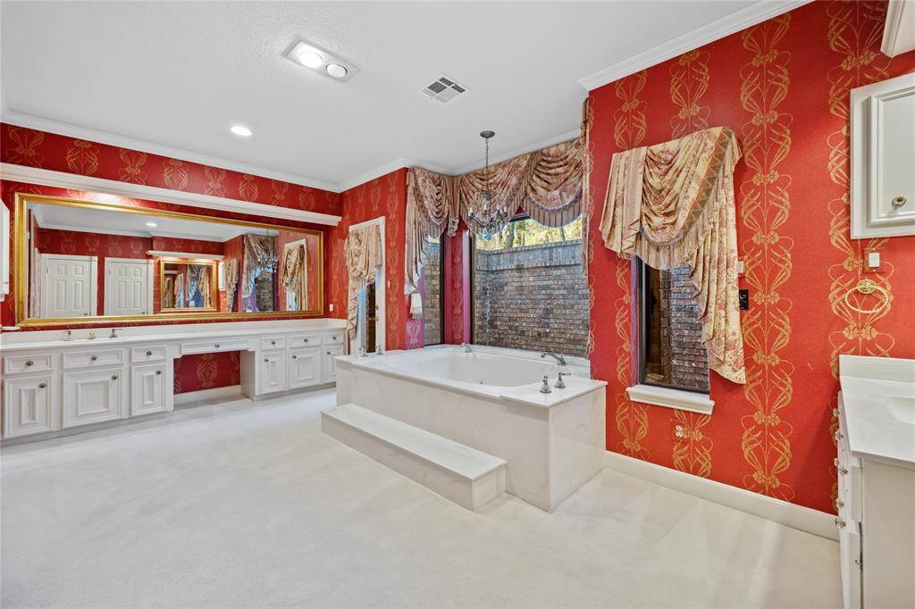 And - the Primary Bath! Private Soaking tub with chandelier overhead... Vanity seating... Lots of storage...