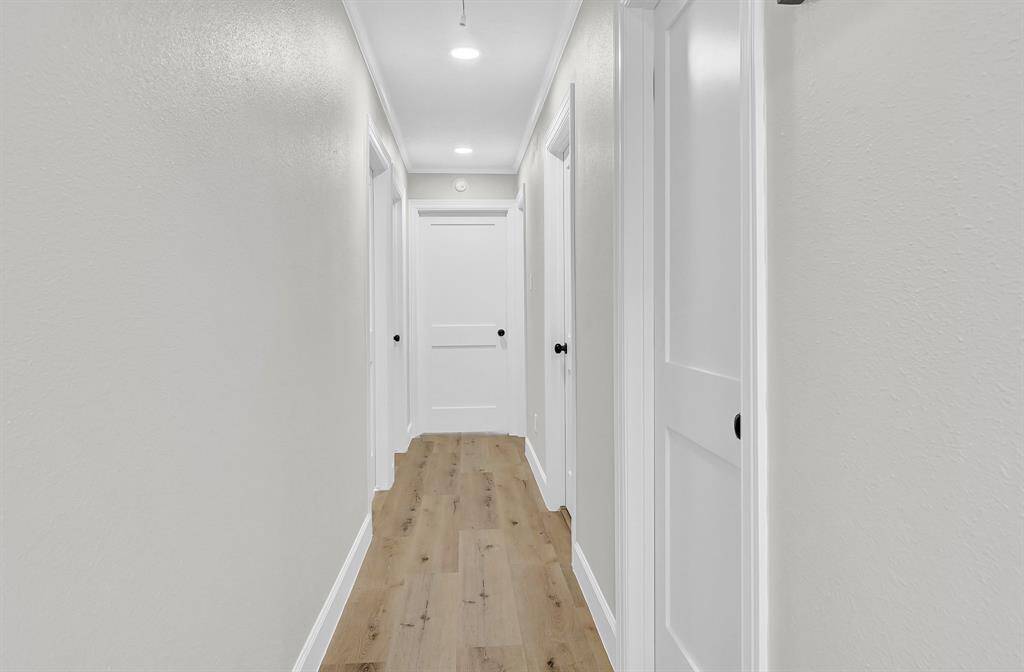 This thoughtfully designed split floor plan offers privacy by separating the master suite from the secondary bedrooms, ensuring a peaceful retreat. Conveniently located on the right, the utility room provides easy access for laundry and storage needs, enhancing the home's functionality.