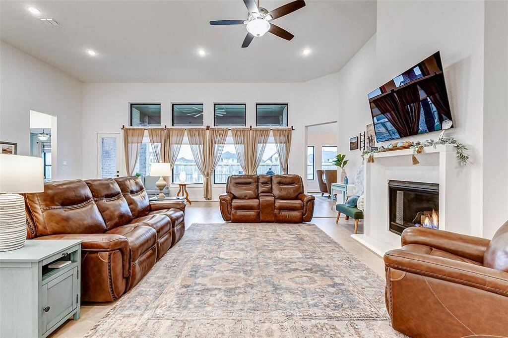 Wall of Windows – Oversized windows flood the space with natural light, offering stunning backyard views.