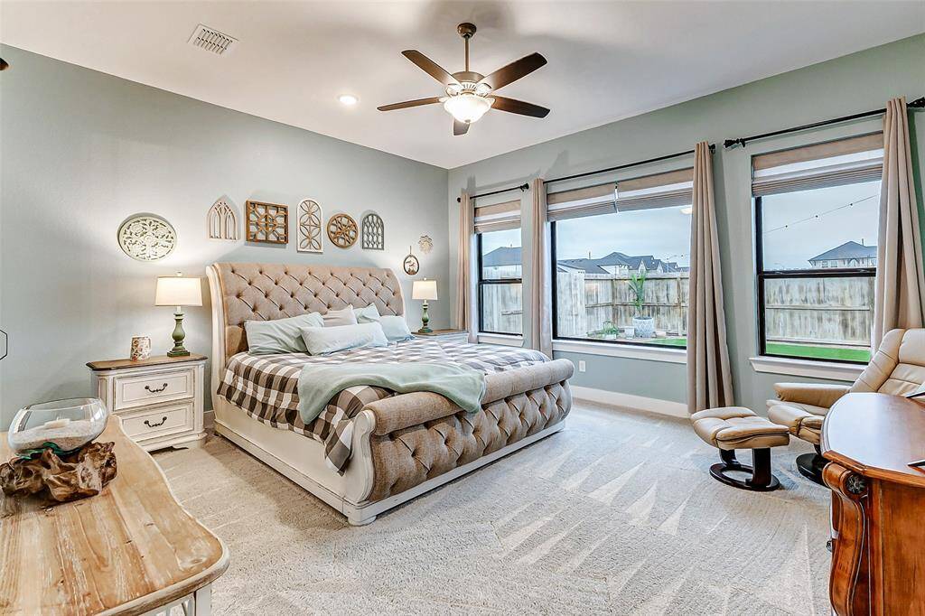 Spacious Primary Bedroom – A serene retreat with high ceilings and large windows for a peaceful atmosphere.