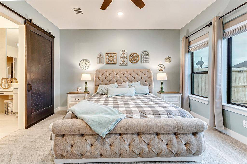 Barn Door Entrance – A stylish custom barn door leads to the spa-like en-suite bath.