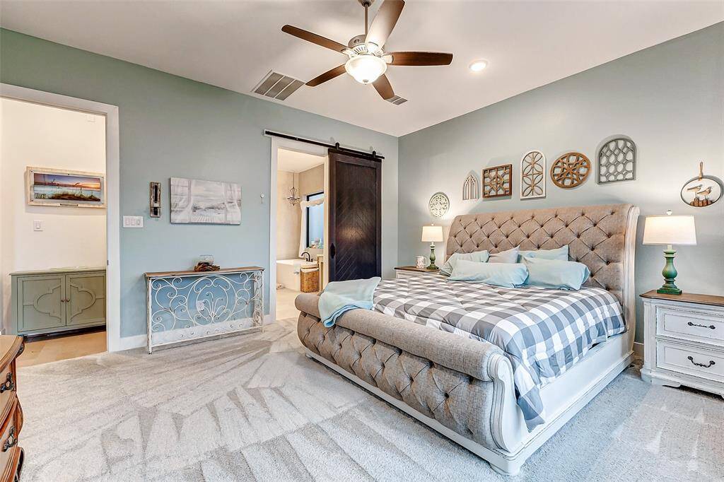 This room feels like a luxury hotel with room for a full suite of furniture and a seating area.