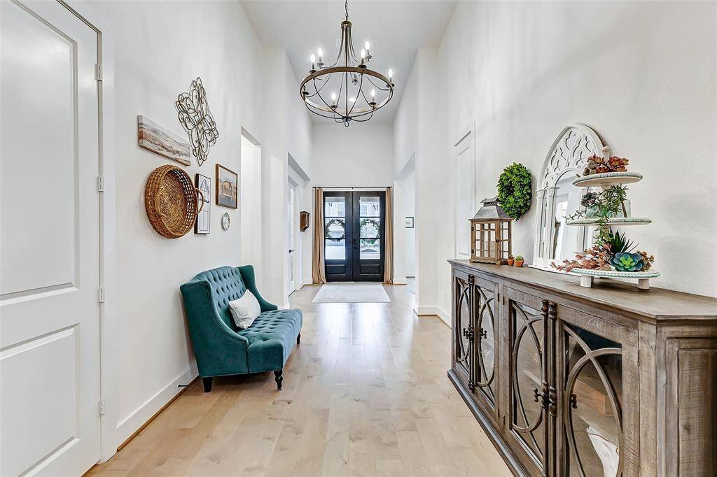 Modern pendant lighting adds elegance to the grand foyer.