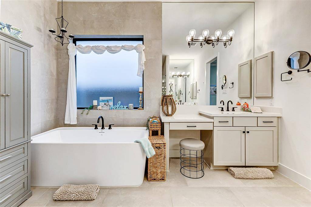 Beautiful lighting encased in a wall of mirrors make sitting at the vanity to get ready for your day a true delight!