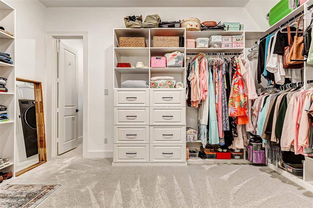 Custom Walk-In Closet – A $9,000 Closets by Design system offers organized storage and boutique-style elegance.