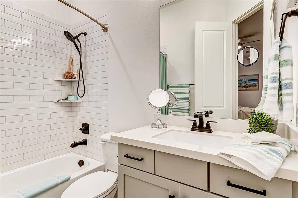 Each secondary bath is equipped with a tub and shower with elegant tile surround, modern dove gray vanities and so much more.