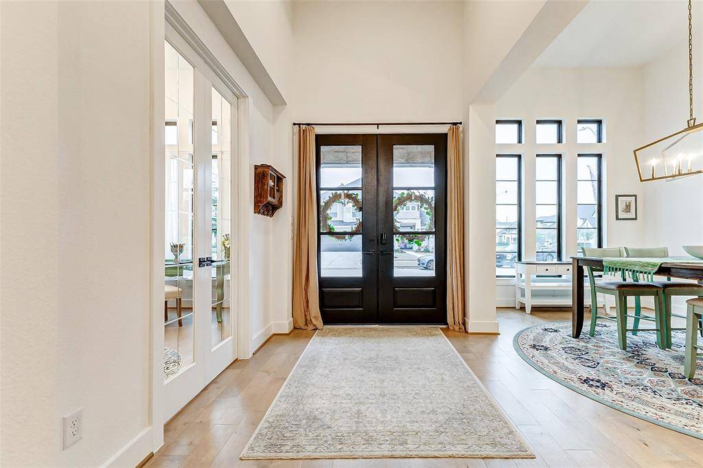 The entryway boasts 14-ft ceilings, setting the stage for a bright and airy home.