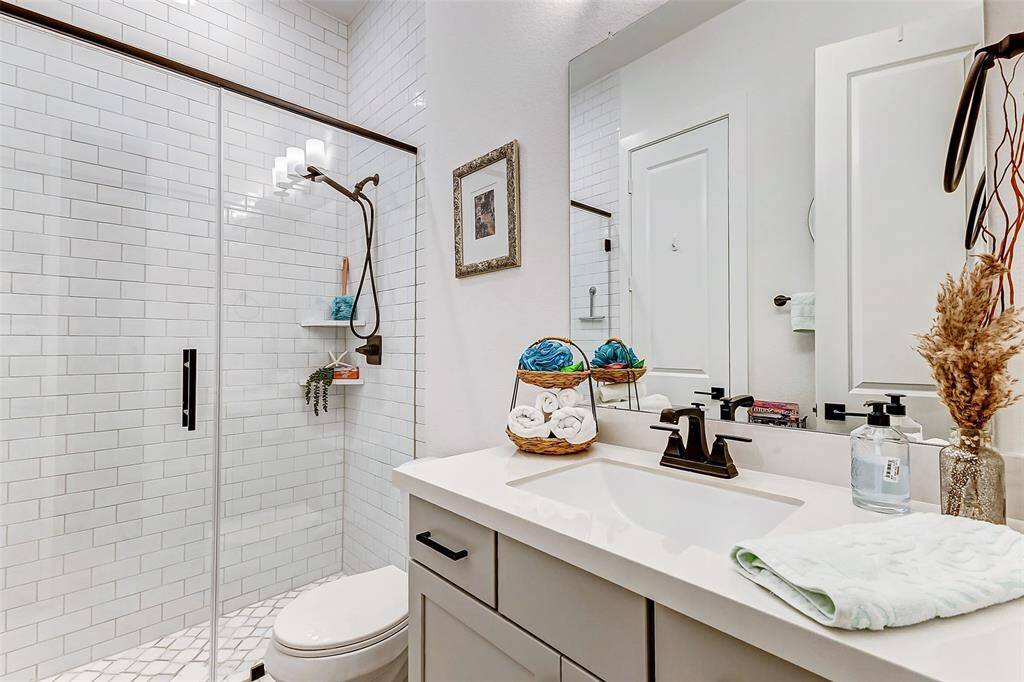 Each secondary bath is equipped with a tub and shower with elegant tile surround, modern dove gray vanities and so much more.
