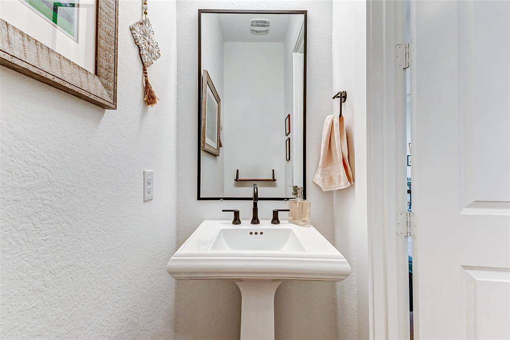 The powder room offers privacy and a touch of sophistication with the beautiful finishes.