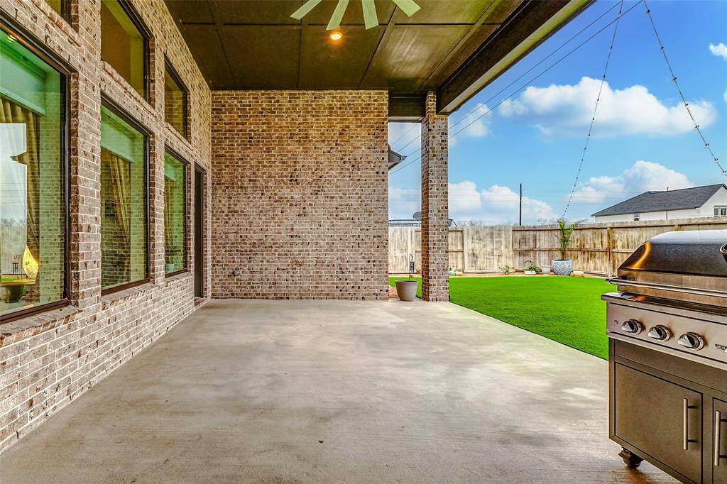 Covered Patio with Ceiling Fan – A shaded retreat for relaxing or entertaining year-round.