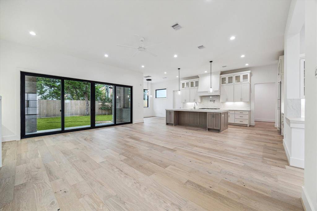 View through family room toward kitchen / breakfast room. Entry to mudroom and garage is in background, on the right.