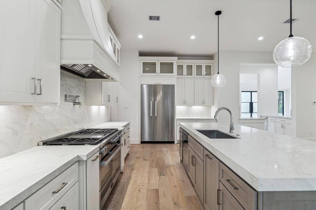 Miele appliances feature 48" gas range with 6 burners / griddle, double ovens that offer convection, steam cooking and microwave, 48" refrigerator / freezer and dishwasher. Quartz counter tops and backsplash with under-cabinet LED lighting that can be adjusted to warmer or cooler hues.