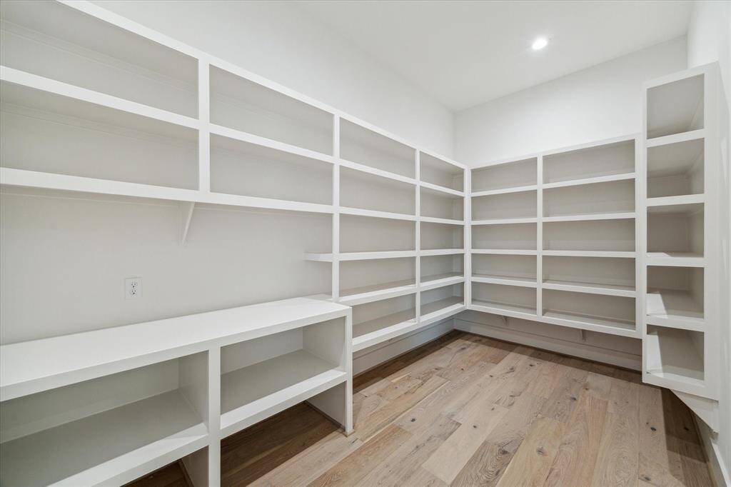 Walk in pantry with room and electrical connection for beverage refrigerator or additional freezer.