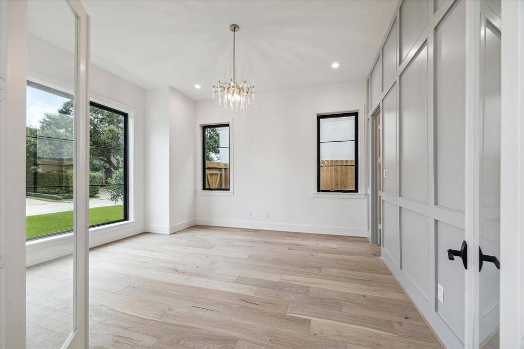 Study or formal living room with block-panelled accent wall, storage closet and floor to ceiling eastern exposure, HDTV drop and speaker prewire.