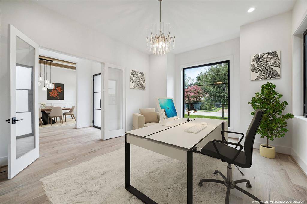 Virtually staged study with view toward foyer and formal dining room.