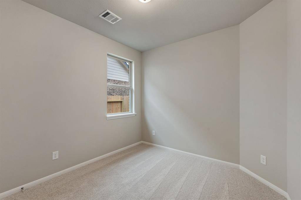 Your secondary bedroom features plush carpet, fresh paint, closet, and a large window that lets in plenty of natural lighting.
