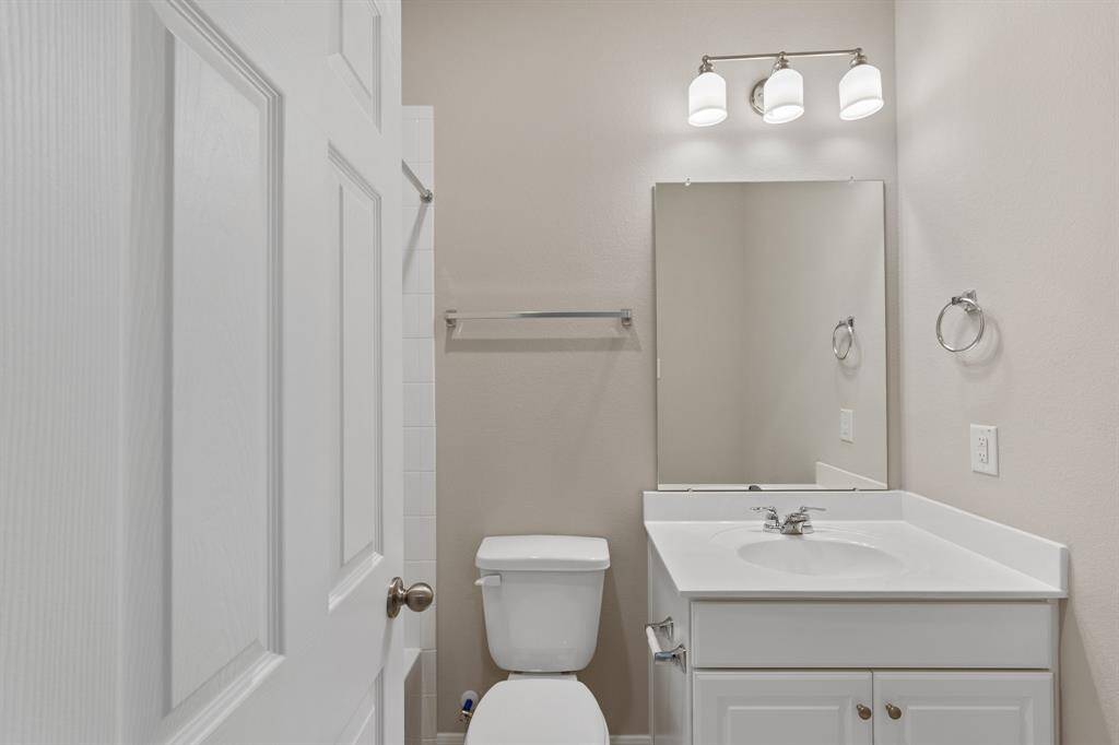 The secondary bath features tile flooring, white cabinetry and light countertops and a shower/tub combo. Perfect for accommodating any visiting family and friends.