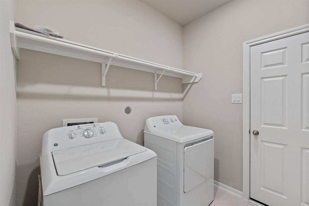 The laundry room layout is carefully planned for optimal workflow with designated areas for washing, drying, and storing.