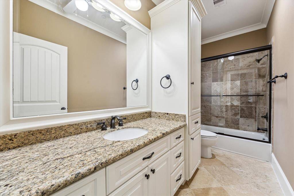 Each bedroom has its own Ensuite bath! Full Ensuite bath, located off the secondary bedroom, highlights ample counter space with cabinet storage below, linen cabinet, and a tub/shower combo with a sliding glass door.