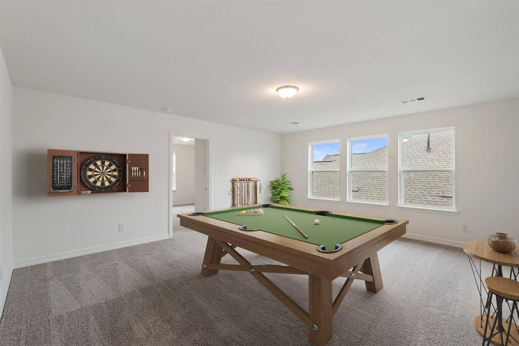 As you make your way upstairs this exceptional game room is a standout feature in this remarkable property, offering a space that combines luxury and fun for all ages. Photo is virtually staged