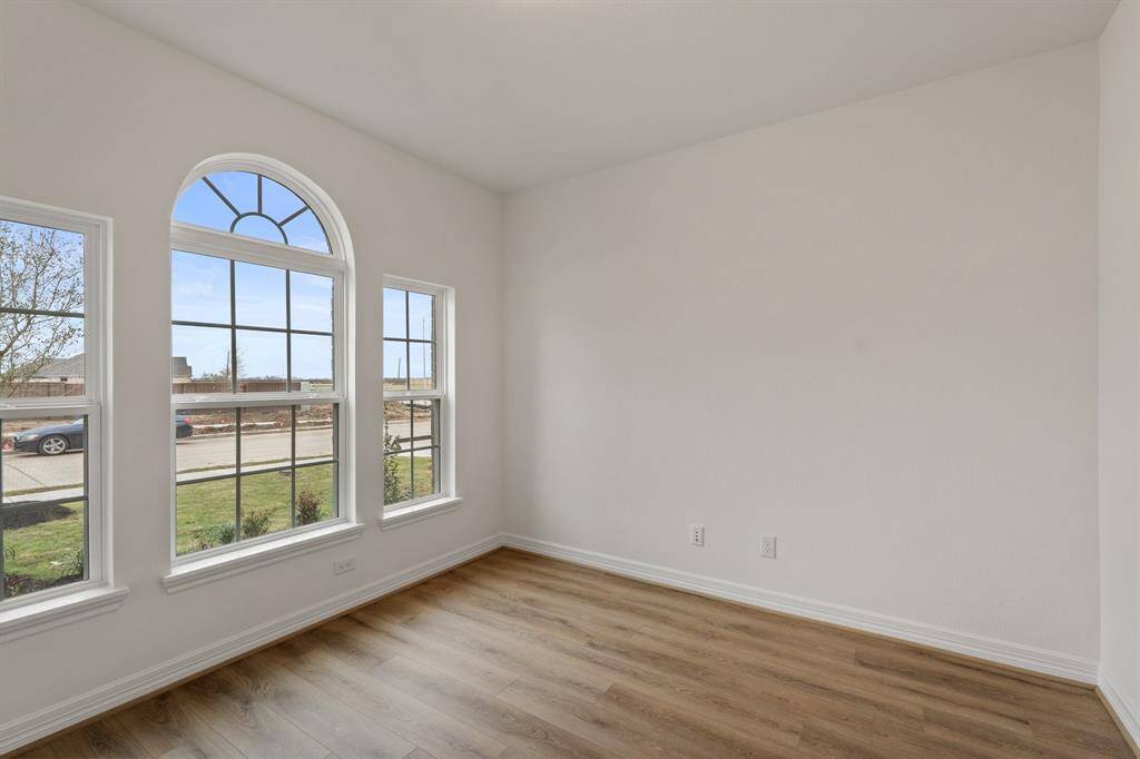 The home office features beautiful floors, large windows that give a fresh feel, this space promotes focus and creativity.