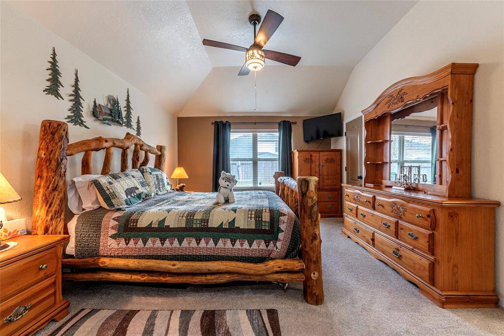 Primary bedroom with a partially vaulted ceiling.