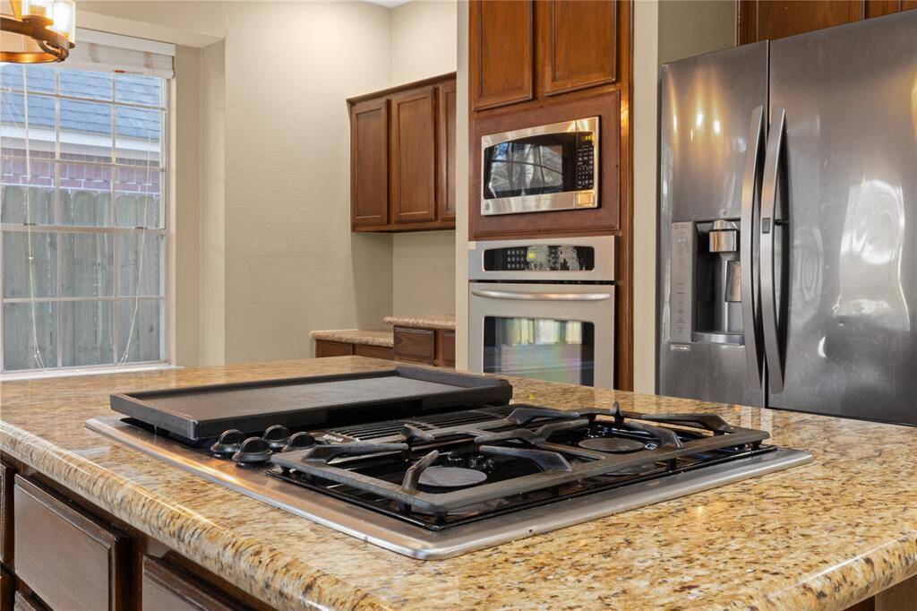Gas cooking completes the draw of the kitchen and family room space.