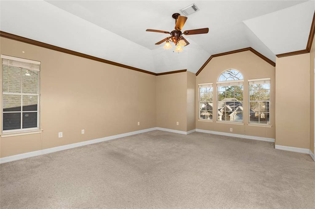 Primary bedroom brags more windows and plenty of space.