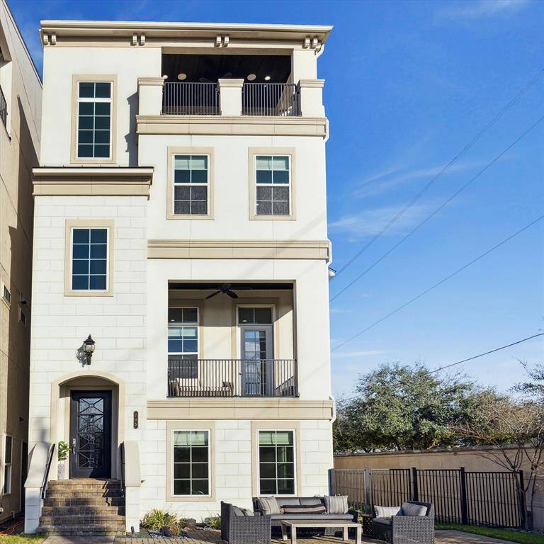 This picturesque 4-story holds a prominent position on a corner lot overlooking the water and walking trail.