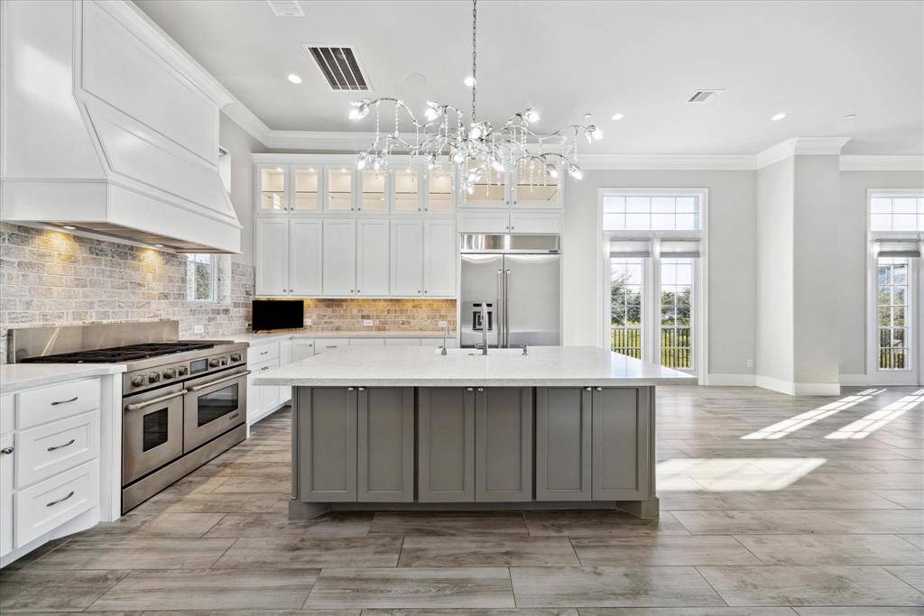 Center kitchen island with extra storage below and room for a row of bar stools for eat-in kitchen.
