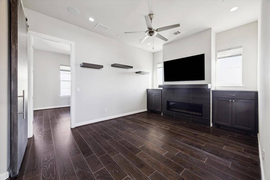 The gameroom, or second living room, located in the middle of the two secondaries on the third floor.  It is warm and inviting with a custom electric fireplace, built-ins and in-ceiling speakers.