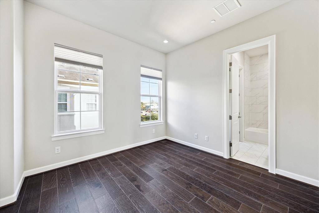 The secondary bedrooms enjoy wood floors, attached baths and walk-in closets.