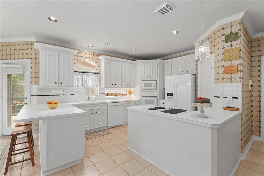 Discover a radiant kitchen with generous storage and sleek recessed lighting. For those that love to remodel there is so much space to change the look.