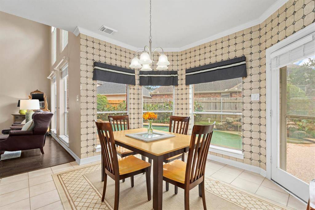 Enjoy mornings in a spacious breakfast room with stunning views of the backyard and pool.