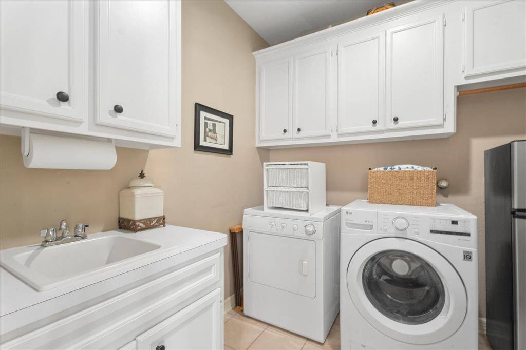 Experience the convenience of a spacious laundry room complete with additional storage and a secondary refrigerator space. Enjoy the practicality of an in-room sink for easy clean-up and garment care.