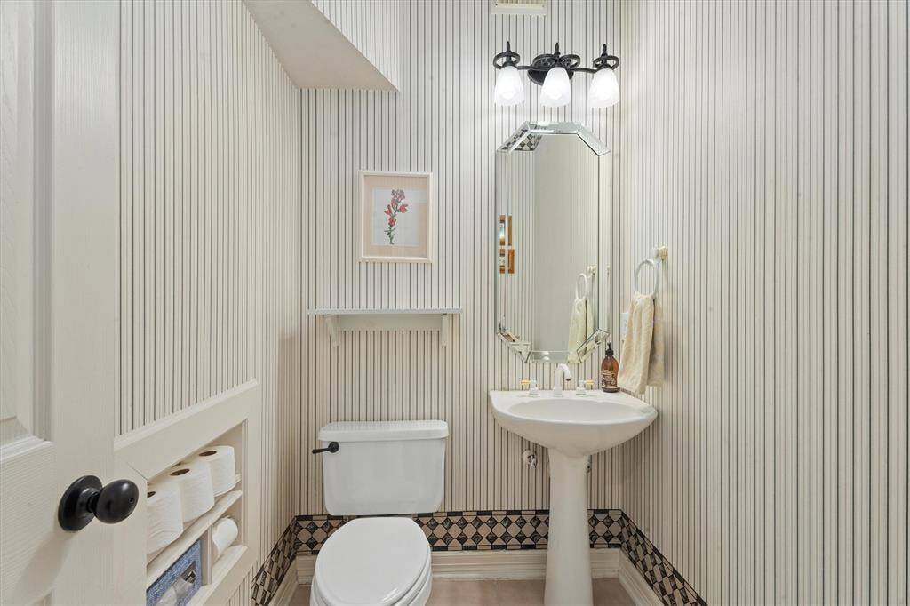 Experience the convenience of a charming powder room directly adjacent to the kitchen area.