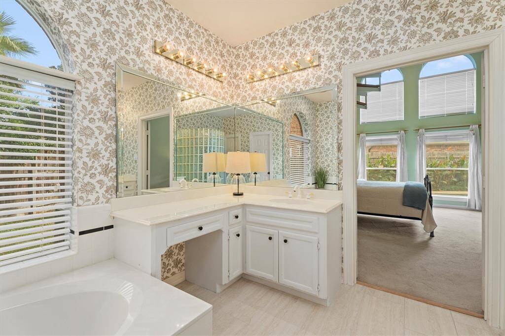 Elegant ensuite with dual vanities and abundant natural light.The tile in the bathroom has recenlty been updated.