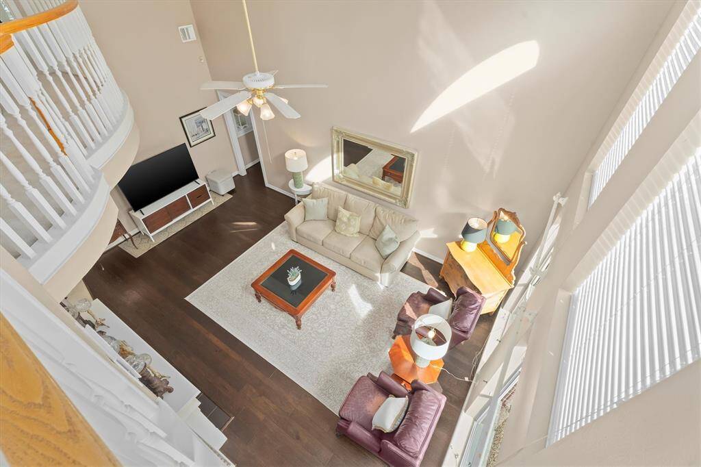 Experience the charm of this living area with a gas log fireplace, elegant wood flooring, and abundant natural light.