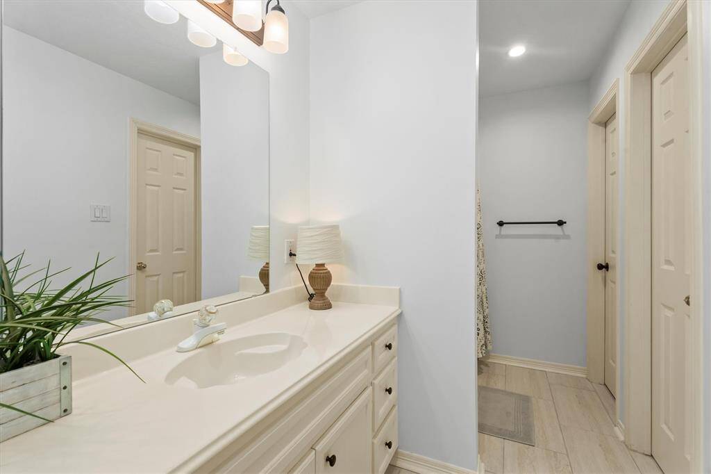 Experience the convenience and elegance of this Jack and Jill bathroom, boasting newly installed tiles, a private water closet, and a dual-access vanity connecting to an adjacent bedroom—perfect for a seamless morning routine. The tile in the bathroom has recently been updated.