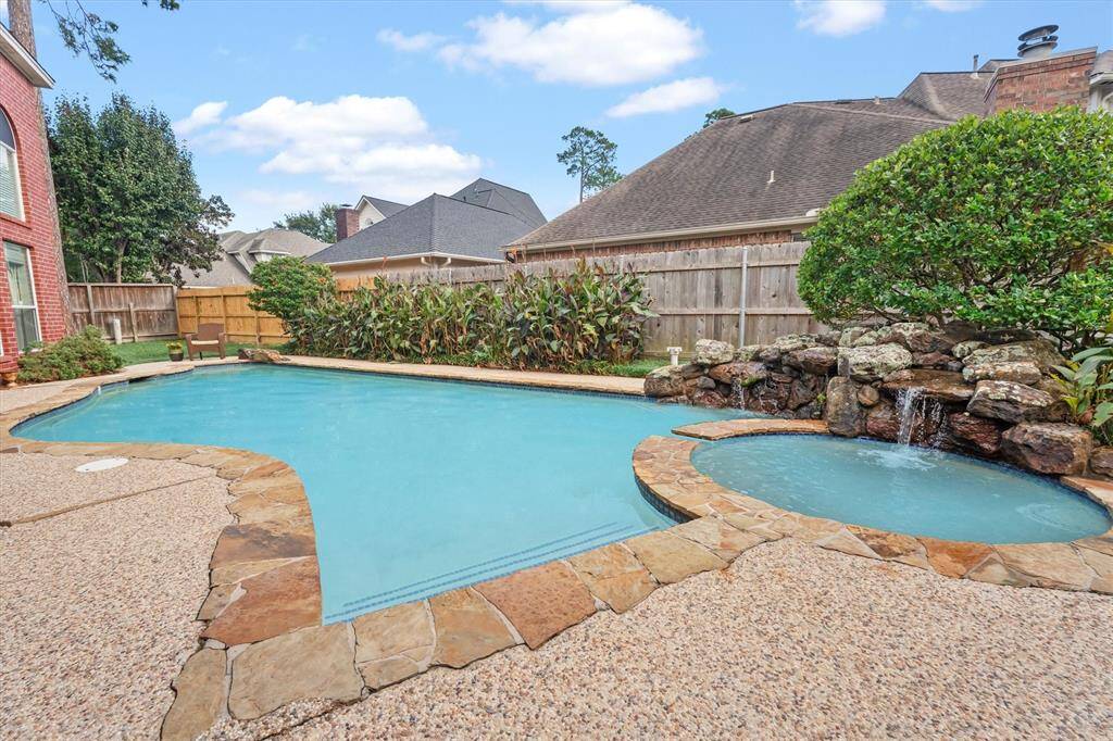 Discover your private oasis, complete with a sparkling pool and lush landscaping.