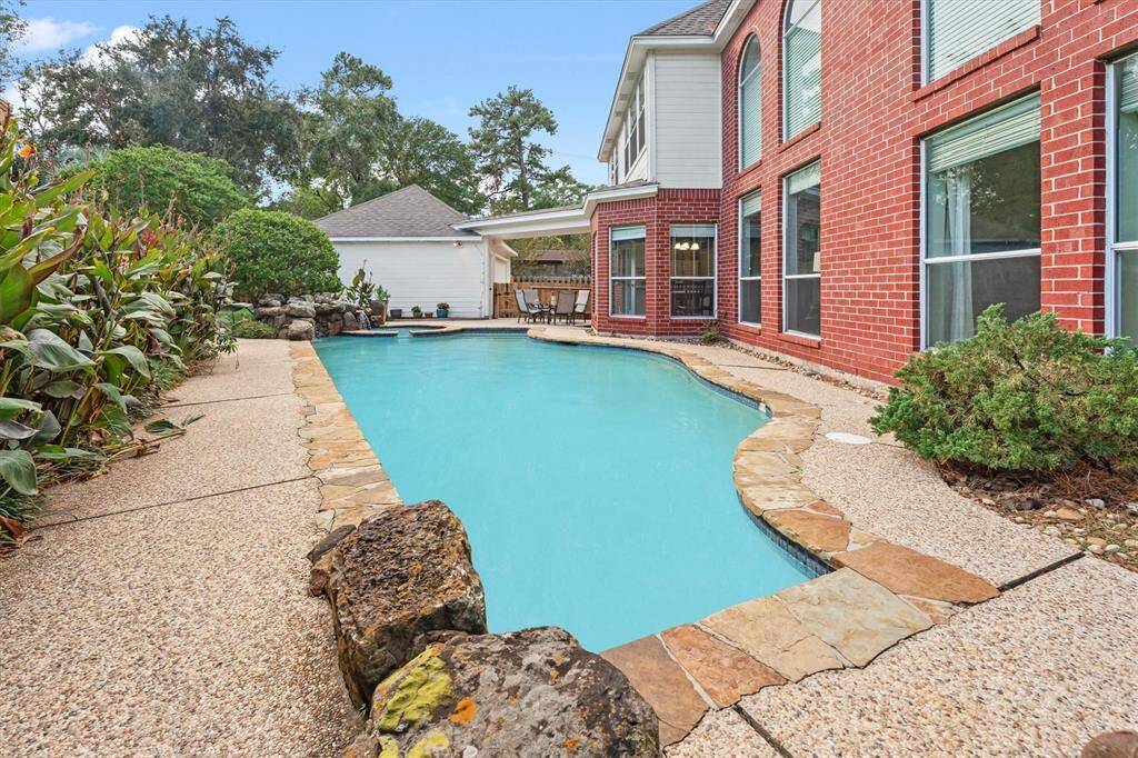 Expansive backyard with a sparkling pool and plenty of space for a play area or outdoor entertainment.