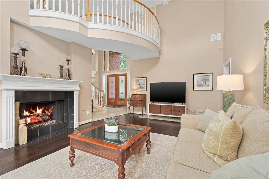 Step into elegance with this spacious living area, complete with a charming Juliet balcony and a cozy fireplace, perfect for both relaxation and entertaining.